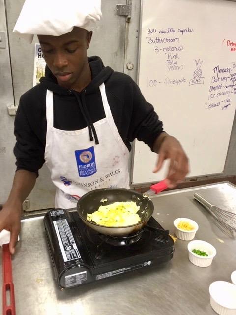 student preparing delicious omlet 