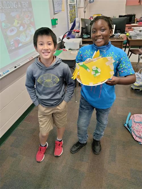 Two students show their work.