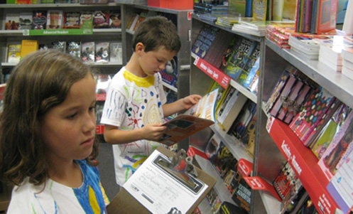 children are looking at books at the book fair