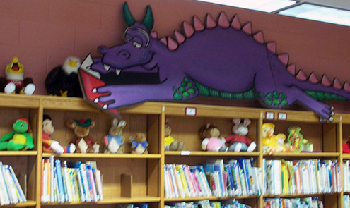 Dragon reading a book