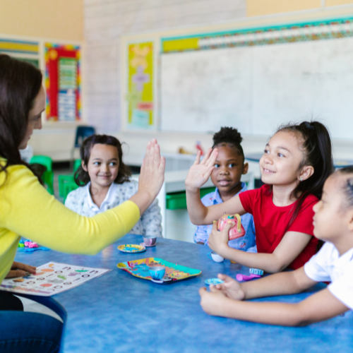 Teacher giving a student a high five Teacher giving a student a high five