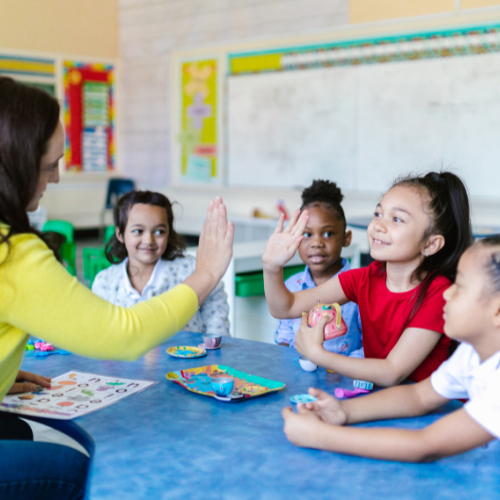 Teacher giving a student a high five